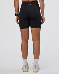 Woman wearing Rep Ultra High-Rise 6" Short Pockets - Black-Ultra Fuchsia | Model:Abbey | Size:S
