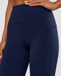 Woman wearing Rep Ultra High-Rise 3/4 Legging Pockets - Future Navy-White | Model:Dakota | Size:S