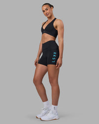 Woman wearing Rep Ultra High-Rise 4" Short Pockets - Black-Blue Atoll | Model:Sophie | Size:S