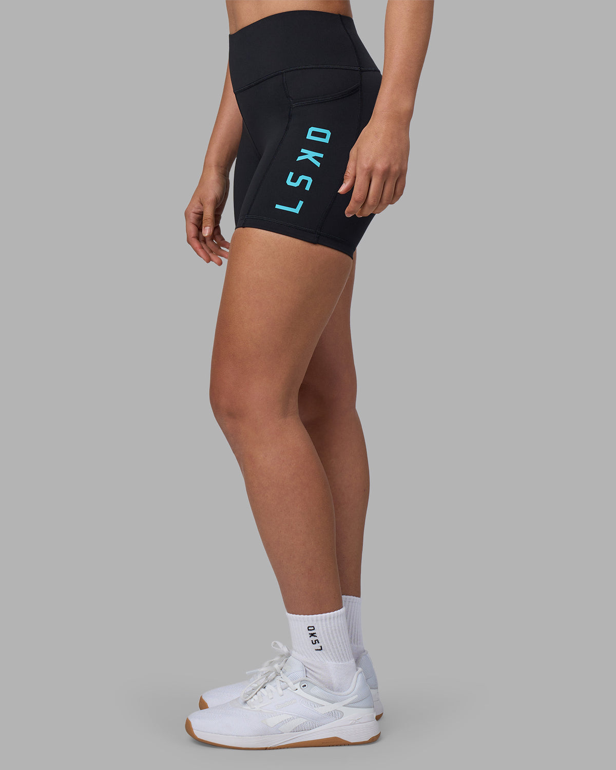 Woman wearing Rep Ultra High-Rise 4" Short Pockets - Black-Blue Atoll | Model:Sophie | Size:S
