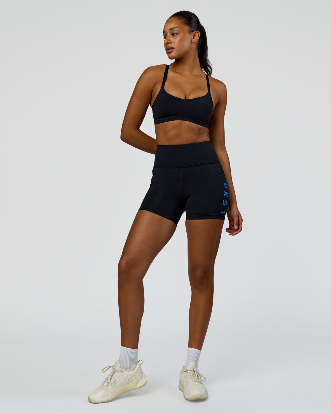 Woman wearing Rep Ultra High-Rise 4" Short Pockets - Black-Palace Blue | Model:Rosie | Size:S