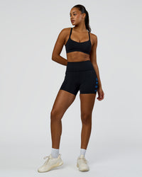 Woman wearing Rep Ultra High-Rise 4" Short Pockets - Black-Palace Blue | Model:Rosie | Size:S