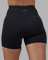 Woman wearing Rep Ultra High-Rise 4" Short Pockets - Black-Power Cobalt | Model:Rhiley | Size:S | Thumbnail Index: 7