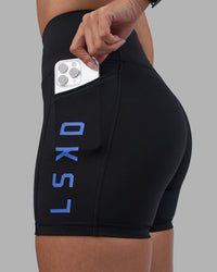 Woman wearing Rep Ultra High-Rise 4" Short Pockets - Black-Power Cobalt | Model:Rhiley | Size:S | Thumbnail Index: 5