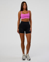 Woman wearing Rep Ultra High-Rise 4" Short Pockets - Black-Ultra Fuchsia | Model:Bianca | Size:S