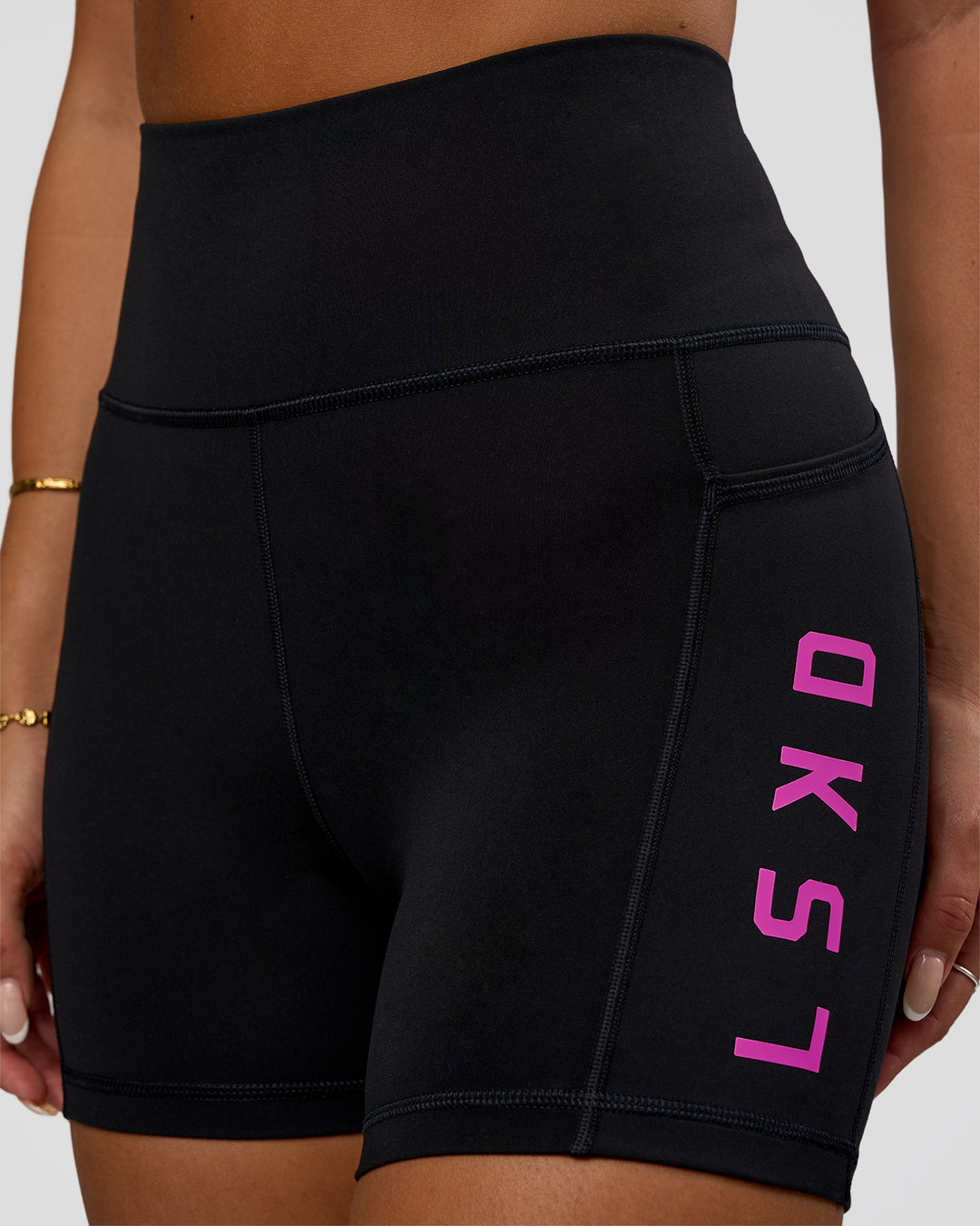 Woman wearing Rep Ultra High-Rise 4&quot; Short Pockets - Black-Ultra Fuchsia | Model:Bianca | Size:S