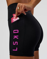Woman wearing Rep Ultra High-Rise 4" Short Pockets - Black-Ultra Fuchsia | Model:Bianca | Size:S