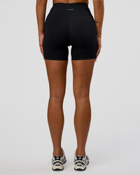 Woman wearing Rep Ultra High-Rise 4" Short Pockets - Black-Ultra Fuchsia | Model:Bianca | Size:S