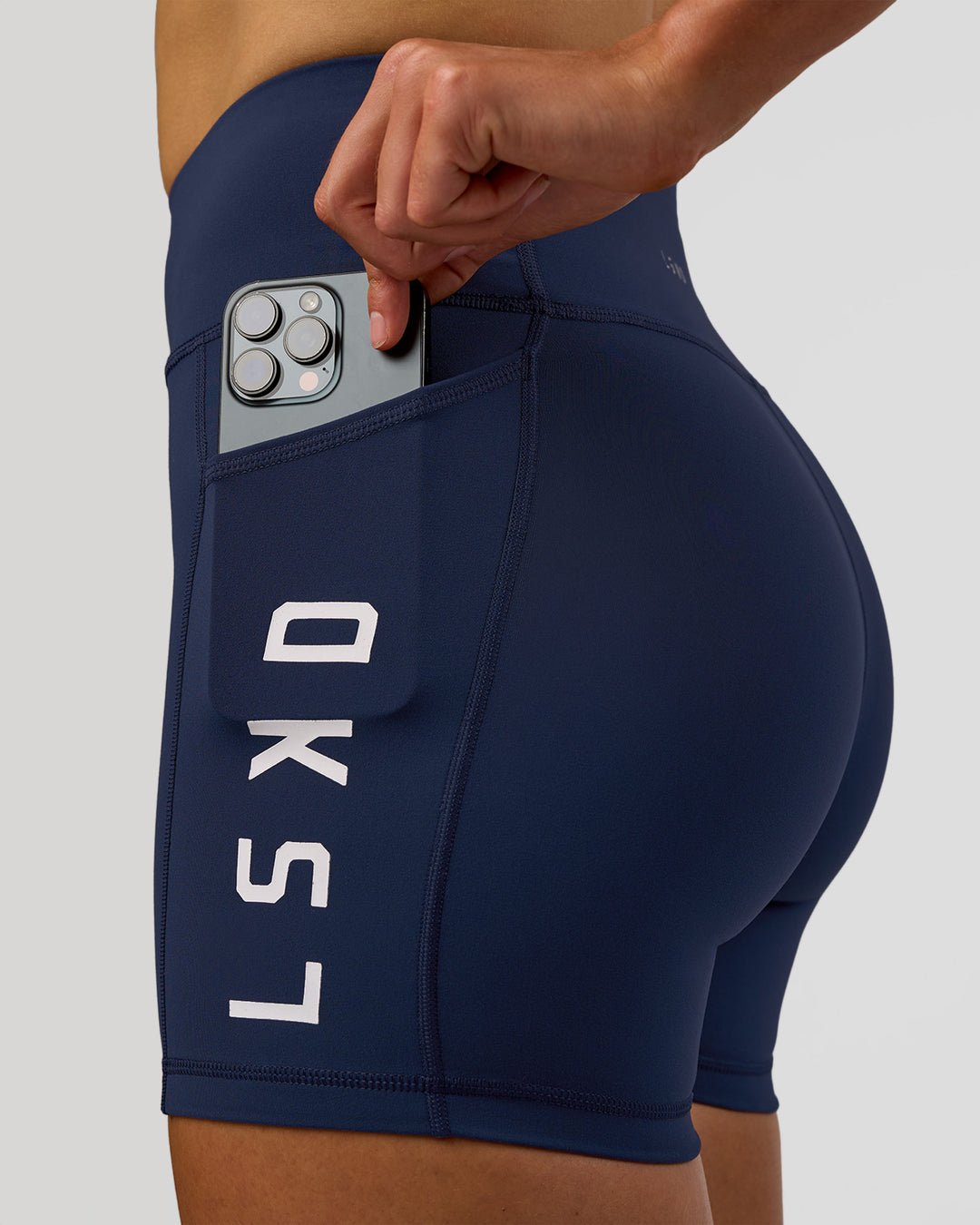 Woman wearing Rep Ultra High-Rise 4" Short Pockets - Future Navy-White | Model:Evie | Size:S