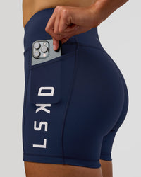 Woman wearing Rep Ultra High-Rise 4" Short Pockets - Future Navy-White | Model:Evie | Size:S