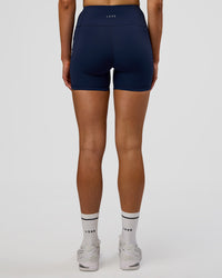 Woman wearing Rep Ultra High-Rise 4" Short Pockets - Future Navy-White | Model:Evie | Size:S