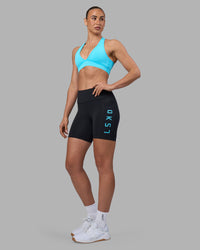 Woman wearing Rep Ultra High-Rise 6" Short Pockets - Black-Blue Atoll | Model:Sophie | Size:S