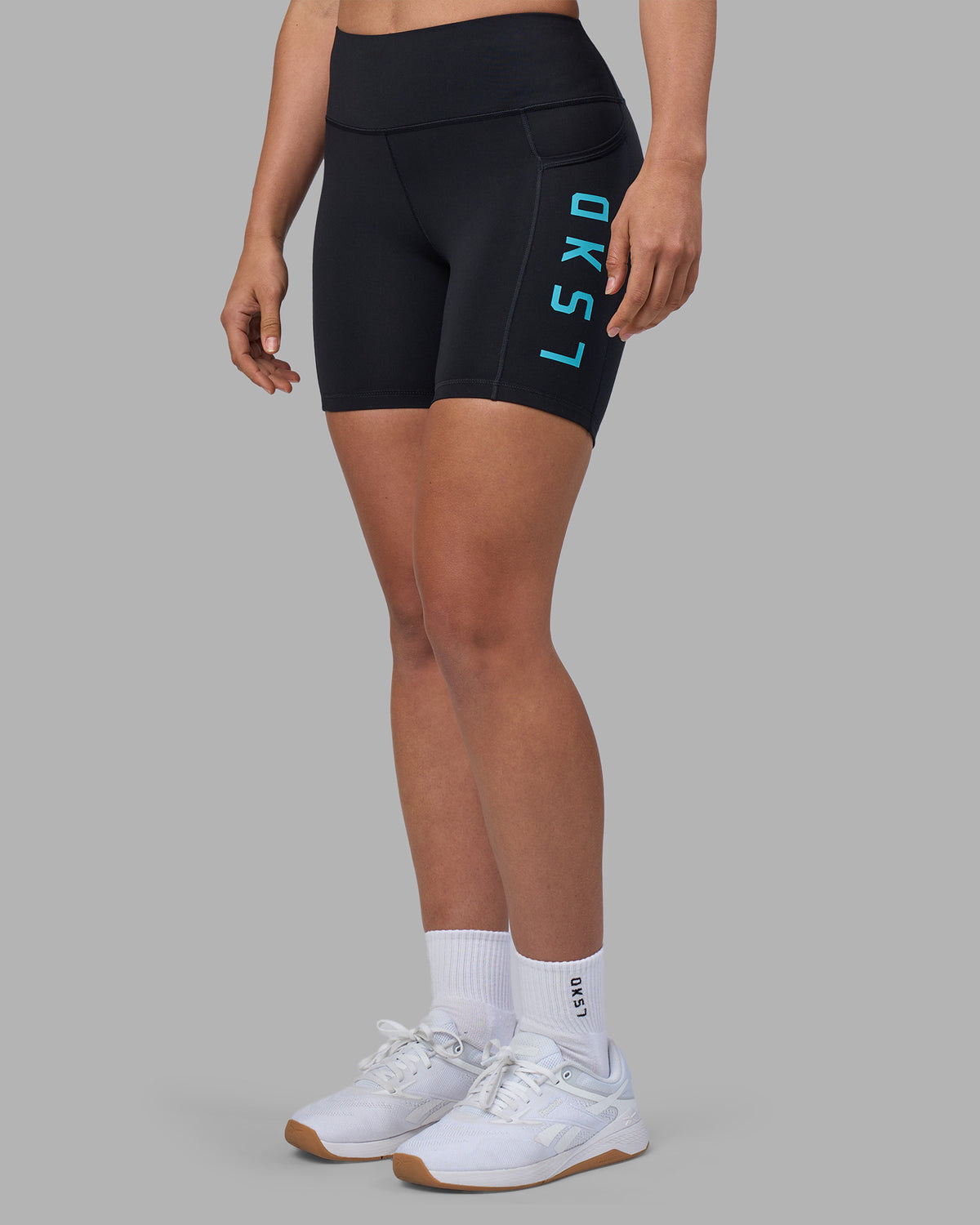 Woman wearing Rep Ultra High-Rise 6" Short Pockets - Black-Blue Atoll | Model:Sophie | Size:S