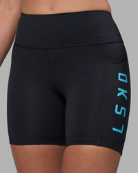 Woman wearing Rep Ultra High-Rise 6" Short Pockets - Black-Blue Atoll | Model:Sophie | Size:S