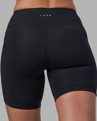 Woman wearing Rep Ultra High-Rise 6" Short Pockets - Black-Blue Atoll | Model:Sophie | Size:S