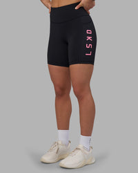 Woman wearing Rep Ultra High-Rise 6" Short Pockets - Black-Candy Pink | Model:Keisha | Size:S