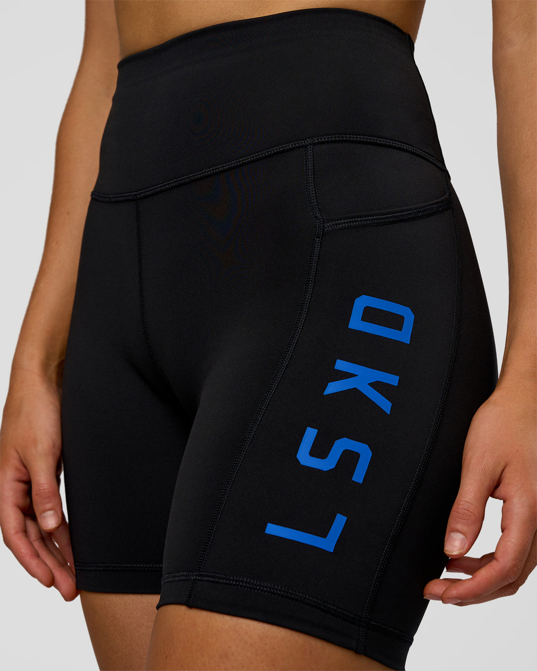 Woman wearing Rep Ultra High-Rise 6" Short Pockets - Black-Electric Indigo | Model:Evie | Size:S