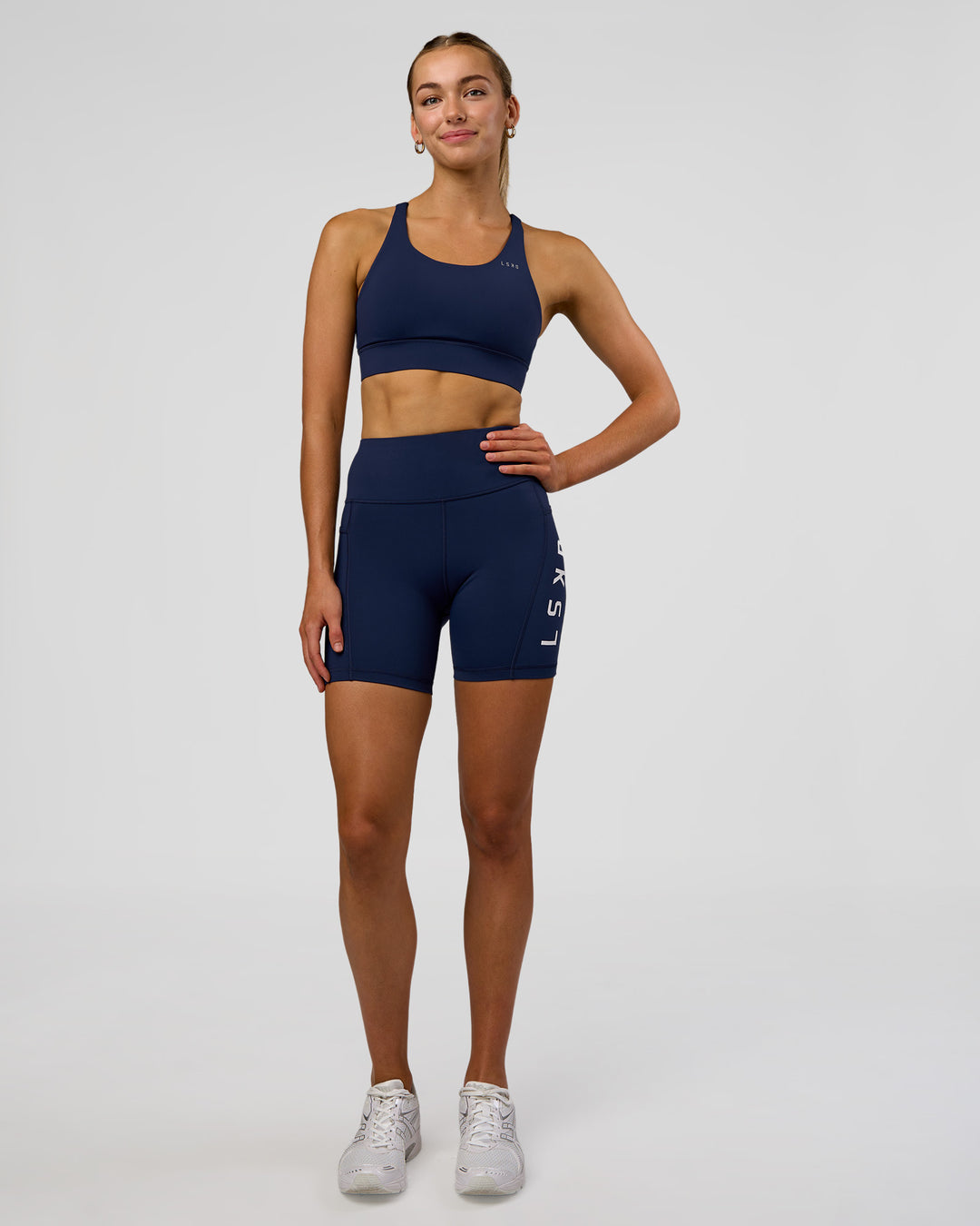 Woman wearing Rep Ultra High-Rise 6" Short Pockets - Future Navy-White | Model:Evie | Size:S