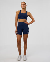Woman wearing Rep Ultra High-Rise 6" Short Pockets - Future Navy-White | Model:Evie | Size:S