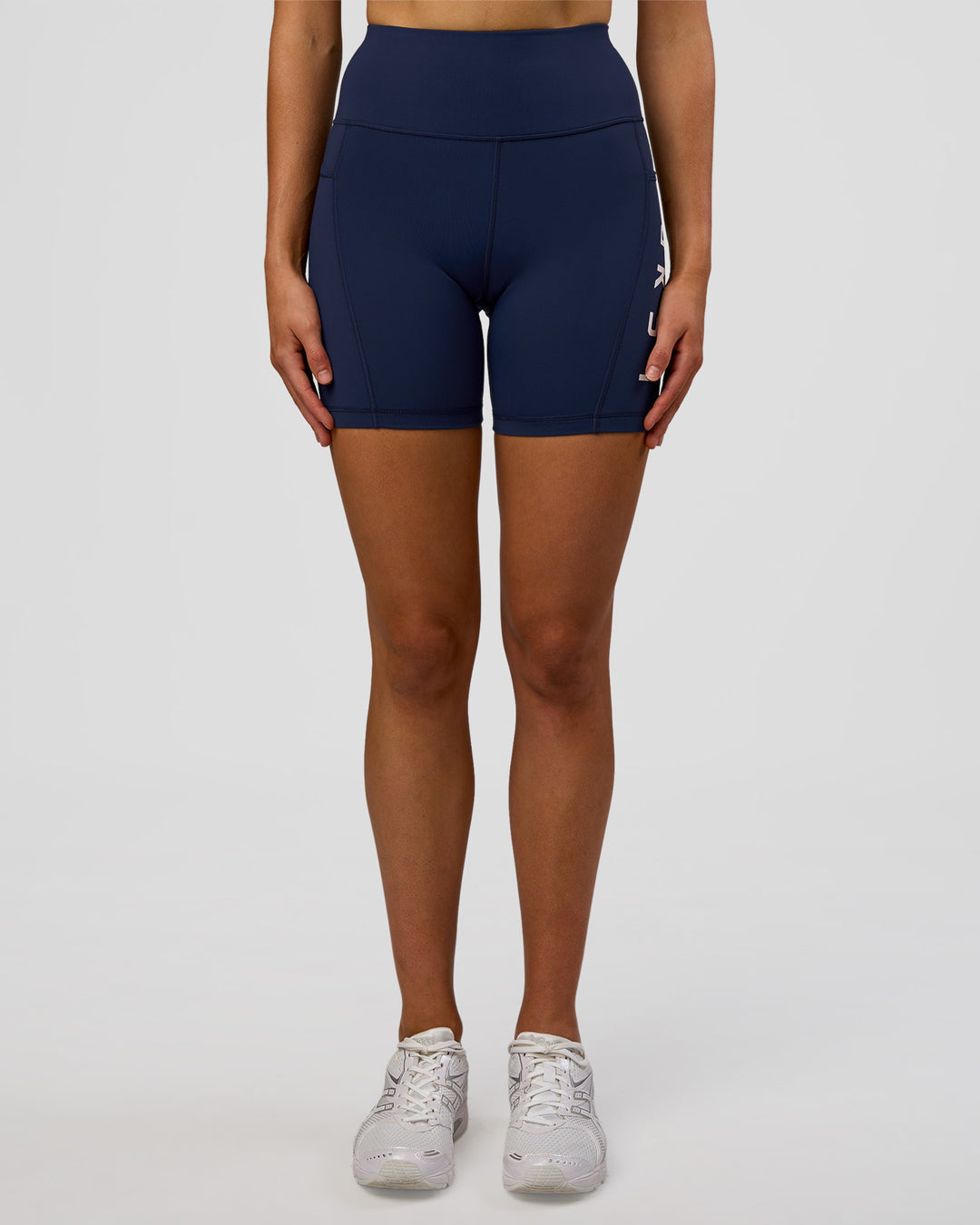 Woman wearing Rep Ultra High-Rise 6" Short Pockets - Future Navy-White | Model:Evie | Size:S