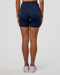 Woman wearing Rep Ultra High-Rise 6" Short Pockets - Future Navy-White | Model:Evie | Size:S