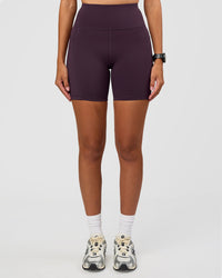 Woman wearing Rep Ultra High-Rise 6" Short Pockets - Midnight Plum-Marshmallow | Model:Rhiley | Size:S