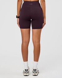 Woman wearing Rep Ultra High-Rise 6" Short Pockets - Midnight Plum-Marshmallow | Model:Rhiley | Size:S