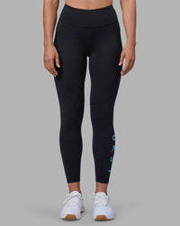 Woman wearing Rep Ultra High-Rise 7/8 Legging Pockets - Black-Blue Atoll | Model:Sophie | Size:S