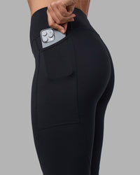 Woman wearing Rep Ultra High-Rise 7/8 Legging Pockets - Black-Blue Atoll | Model:Sophie | Size:S