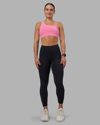 Woman wearing Rep Ultra High-Rise 7/8 Legging Pockets - Black-Candy Pink | Model:Keisha | Size:S