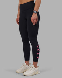 Woman wearing Rep Ultra High-Rise 7/8 Legging Pockets - Black-Candy Pink | Model:Keisha | Size:S