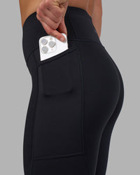 Woman wearing Rep Ultra High-Rise 7/8 Legging Pockets - Black-Candy Pink | Model:Keisha | Size:S