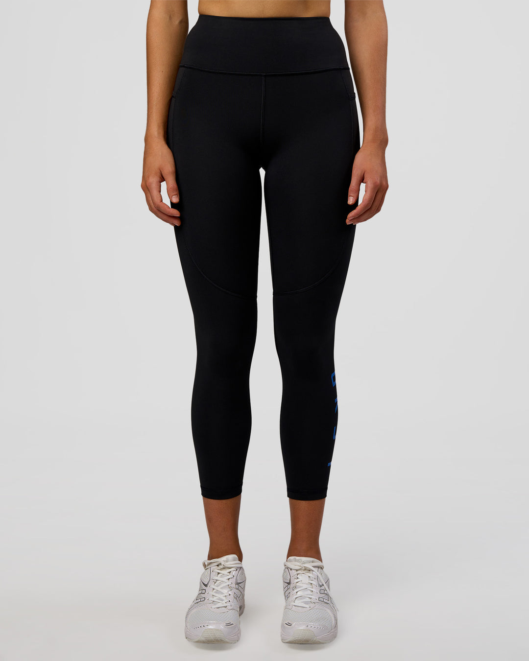 Woman wearing Rep Ultra High-Rise 7/8 Legging Pockets - Black-Electric Indigo | Model:Evie | Size:S
