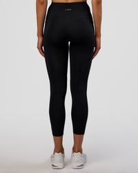 Woman wearing Rep Ultra High-Rise 7/8 Legging Pockets - Black-Electric Indigo | Model:Evie | Size:S