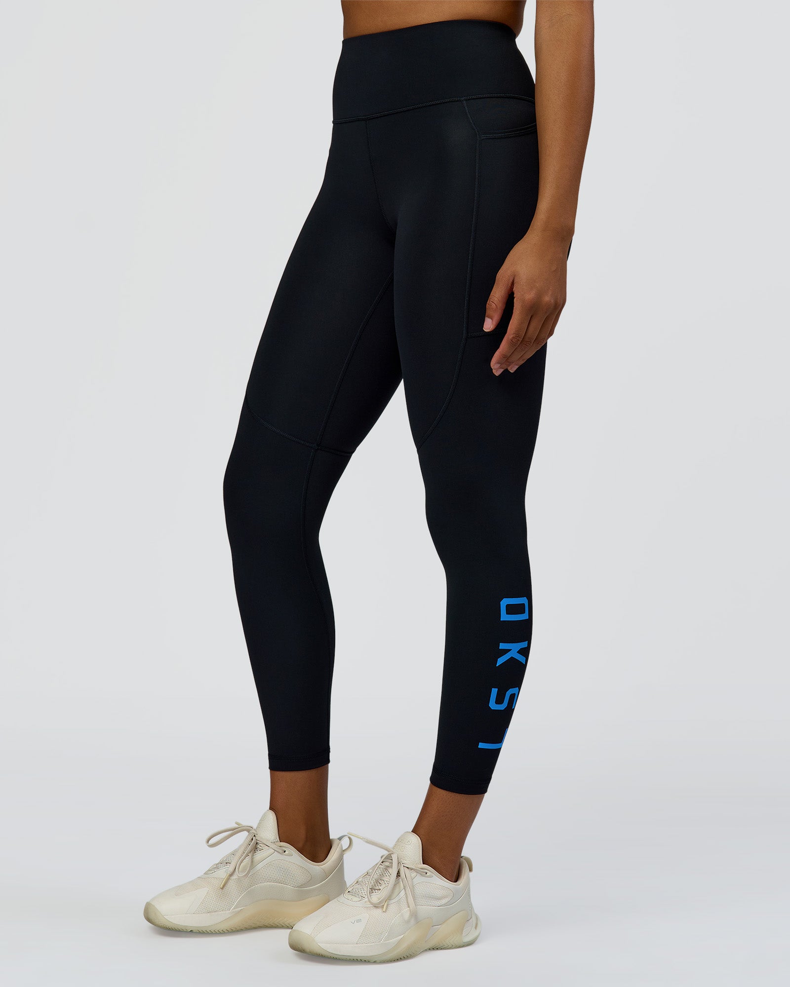 Woman wearing Rep Ultra High-Rise 7/8 Legging Pockets - Black-Palace Blue | Model:Rosie | Size:S