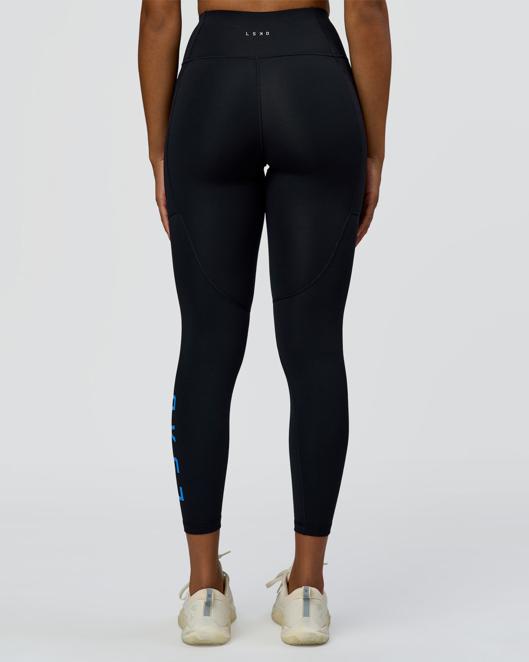 Woman wearing Rep Ultra High-Rise 7/8 Legging Pockets - Black-Palace Blue | Model:Rosie | Size:S