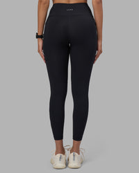 Woman wearing Rep Ultra High-Rise 7/8 Legging Pockets - Black-Power Cobalt | Model:Rhiley | Size:S