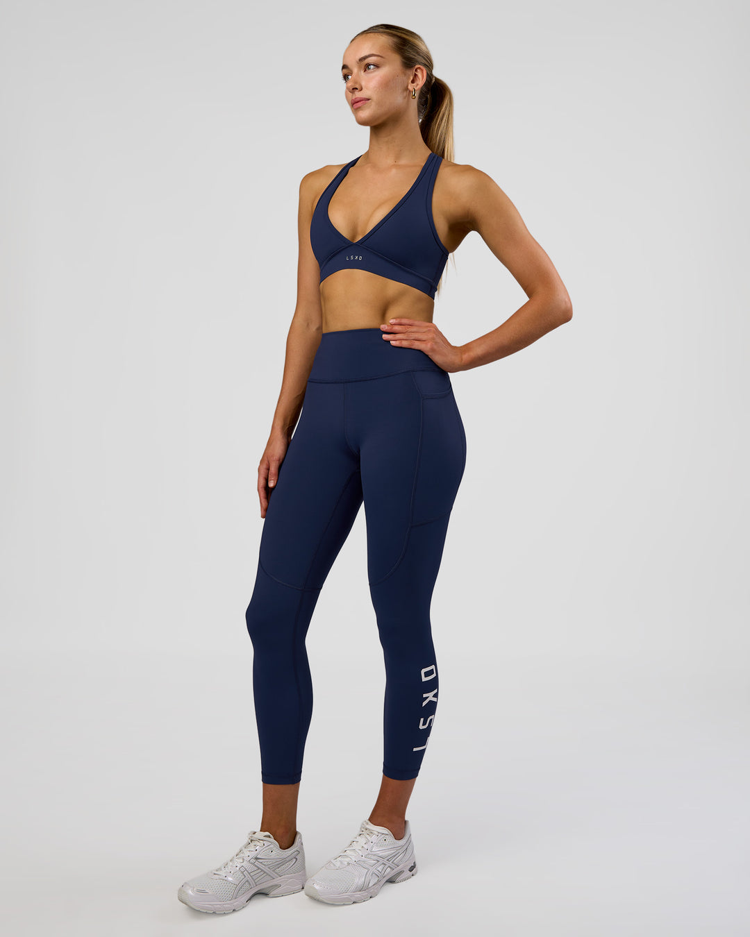 Woman wearing Rep Ultra High-Rise 7/8 Legging Pockets - Future Navy-White | Model:Evie | Size:S