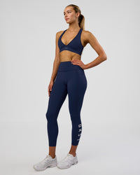 Woman wearing Rep Ultra High-Rise 7/8 Legging Pockets - Future Navy-White | Model:Evie | Size:S