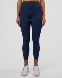 Woman wearing Rep Ultra High-Rise 7/8 Legging Pockets - Future Navy-White | Model:Evie | Size:S