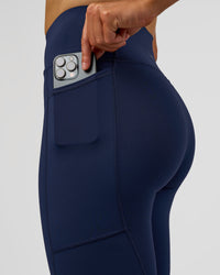 Woman wearing Rep Ultra High-Rise 7/8 Legging Pockets - Future Navy-White | Model:Evie | Size:S