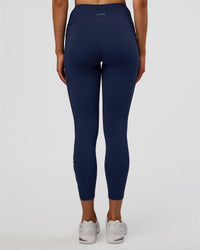 Woman wearing Rep Ultra High-Rise 7/8 Legging Pockets - Future Navy-White | Model:Evie | Size:S