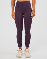 Woman wearing Rep Ultra High-Rise 7/8 Legging Pockets - Midnight Plum-Marshmallow | Model:Emelia | Size:S
