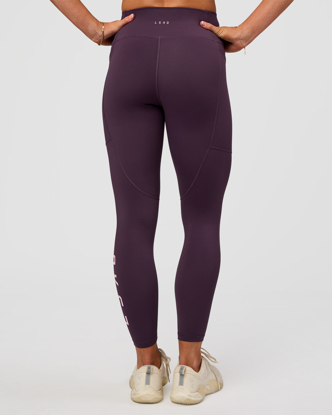Woman wearing Rep Ultra High-Rise 7/8 Legging Pockets - Midnight Plum-Marshmallow | Model:Emelia | Size:S