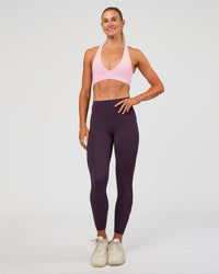Woman wearing Rep Ultra High-Rise 7/8 Legging Pockets - Midnight Plum-Marshmallow | Model:Emelia | Size:S