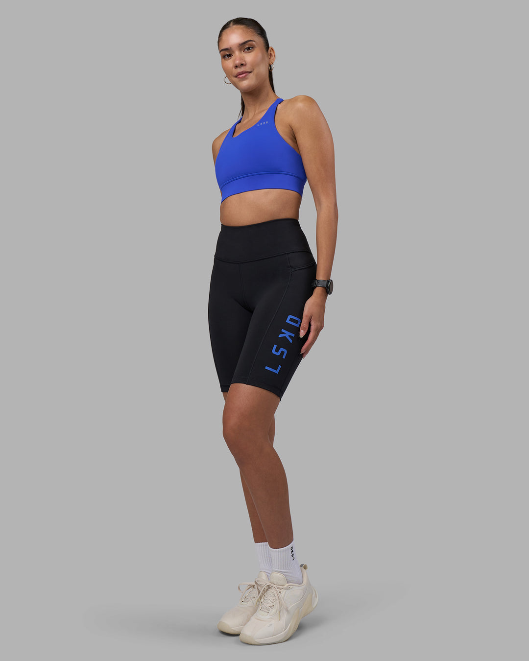 Woman wearing Rep Ultra High-Rise 9&quot; Short Pockets - Black-Power Cobalt | Model:Rhiley | Size:S
