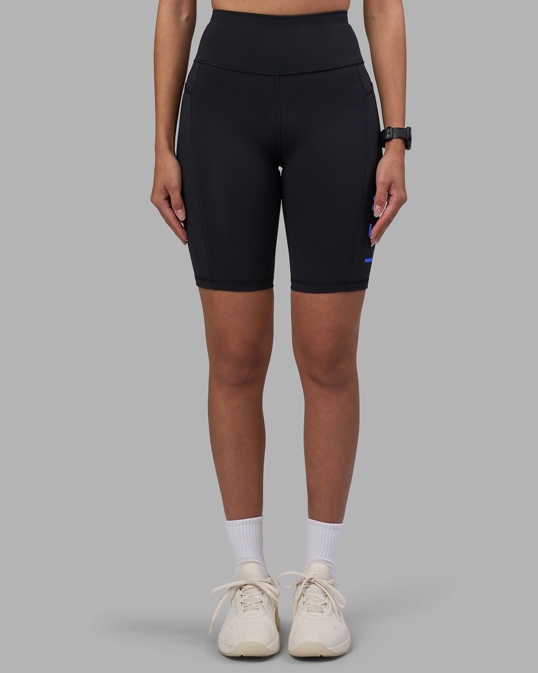 Woman wearing Rep Ultra High-Rise 9&quot; Short Pockets - Black-Power Cobalt | Model:Rhiley | Size:S
