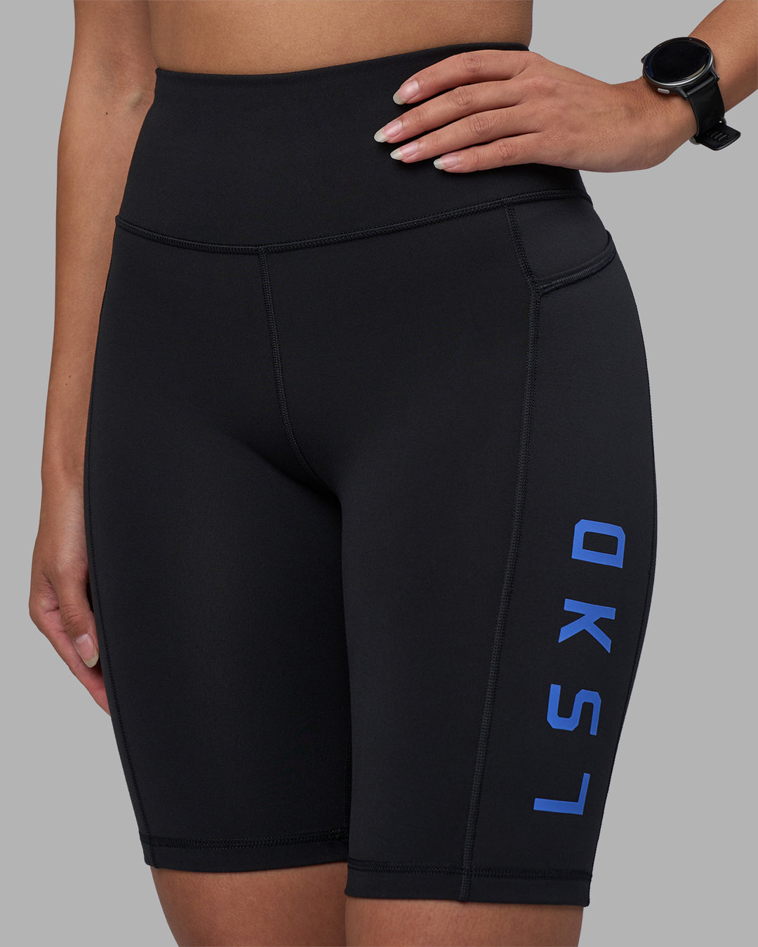 Woman wearing Rep Ultra High-Rise 9&quot; Short Pockets - Black-Power Cobalt | Model:Rhiley | Size:S