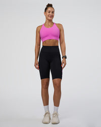 Woman wearing Rep Ultra High-Rise 9" Short Pockets - Black-Ultra Fuchsia | Model:Abbey | Size:S