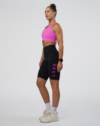 Woman wearing Rep Ultra High-Rise 9" Short Pockets - Black-Ultra Fuchsia | Model:Abbey | Size:S